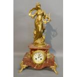 A 19th Century French Variegated Marble and Gilt Metal Mantle Clock surmounted with a Classical