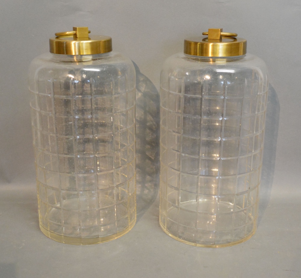 A Pair of Cut Glass and Brass Covered Jars of Circular Form,