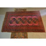 A North West Persian Type Rug with an all over design upon a red and blue ground within multiple