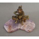 A Patinated Bronze Model in the form of a Monkey upon a Seat upon shaped hardstone stand, 4.