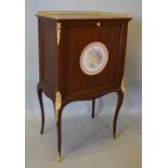 A French Gilt Metal Mounted Side Cabinet with a bass galleried top above a fall front with circular