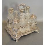 A George IV Silver Cruet Stand, with eight cut glass and silver mounted bottles,