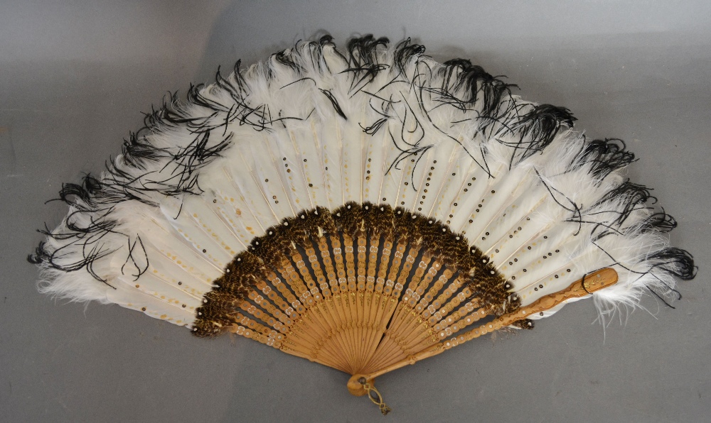 An Ornate Feather Fan with three differe