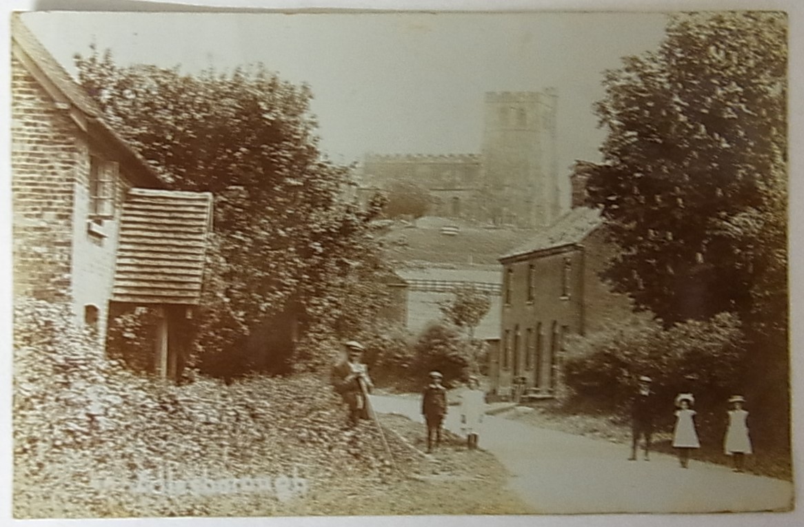 Eldesborough Bucks-Fine RP village street view, church on the hill in the background, locals in