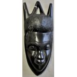 An African Carved wooded face of that very typical hard, dark wood. Measures roughly 10" x 4" a