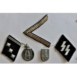 German WWII Militaria including: SS Collar tabs, Ostfront Medal, Officers pip and NCO's Chevron