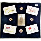 WWI Silk Post Cards mounted on a board and a photograph of a soldier mounted in the centre,