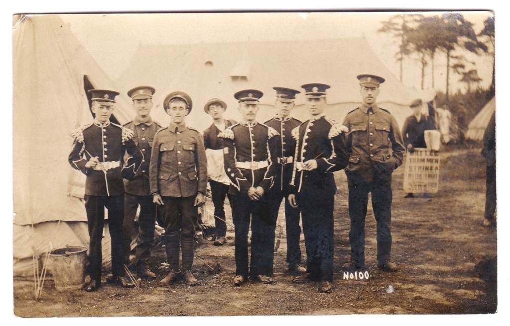 Royal Fusiliers WWI Group Assembled at camp - BIII board behind reads "Will L.E.S. Trammen Stike".