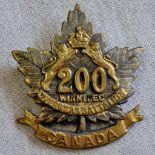 Canadian WWI 200th Winnipeg Overseas Battalion cap badge, small size marked '75 19' (Brass,