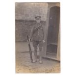 Royal Artillery WWI- Photographic postcard, soldier on duty by a section box, rifle at ease, photo