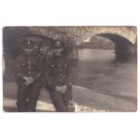 Queens Regiment WWI-two soldiers sit by a bridge in France-rates dark RP postcard