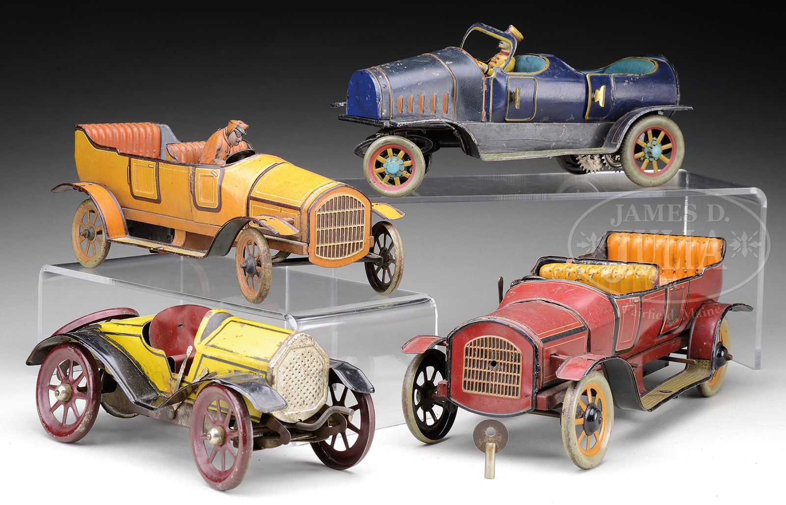 GROUP OF FOUR CLOCKWORK TIN AUTOMOBILE TOYS.