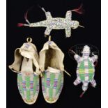 TWO PLAINS UMBILICAL EFFIGY FETISHES TOGETHER WITH PAIR OF LATE NINETEENTH CENTURY MOCCASINS.