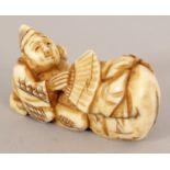 A SIGNED JAPANESE MEIJI PERIOD IVORY NETSUKE OF EBISU KNEELING BEFORE A BAG, and holding a fan,