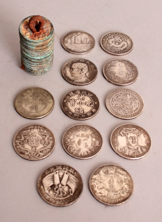 A GROUP OF TWELVE CHINESE SILVER-METAL COINS, each 1.5in diameter; together with a string of