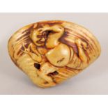 A JAPANESE MEIJI PERIOD IVORY SHELL NETSUKE, its underside surface carved with Okame, the upper