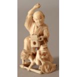 A JAPANESE MEIJI PERIOD IVORY OKIMONO OF A MAN, subduing two oni, 2.8in high.