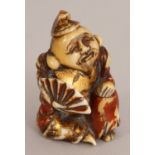 A SIGNED JAPANESE LACQUERED & GILDED IVORY NETSUKE OF EBISU, kneeling and holding a fan, the base