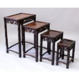 A NEST OF FOUR EARLY 20TH CENTURY CHINESE CARVED HARDWOOD RECTANGULAR TABLES, each with pierced