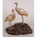 A SIGNED JAPANESE MEIJI PERIOD SILVER-METAL & BRONZE PAIR OF CRANES, each silver-metal bird standing