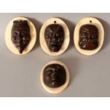 A GROUP OF FOUR JAPANESE MEIJI PERIOD BRONZE NOH MASKS, each mounted on an oval ivory plaque and