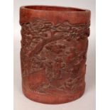 A CHINESE BAMBOO BRUSHPOT, decorated in relief with sages in a continuous landscape setting, 5.1in