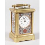 A MINIATURE FRENCH BRASS AND CLOISSONE ENAMEL CARRIAGE CLOCK. 2.75ins high.