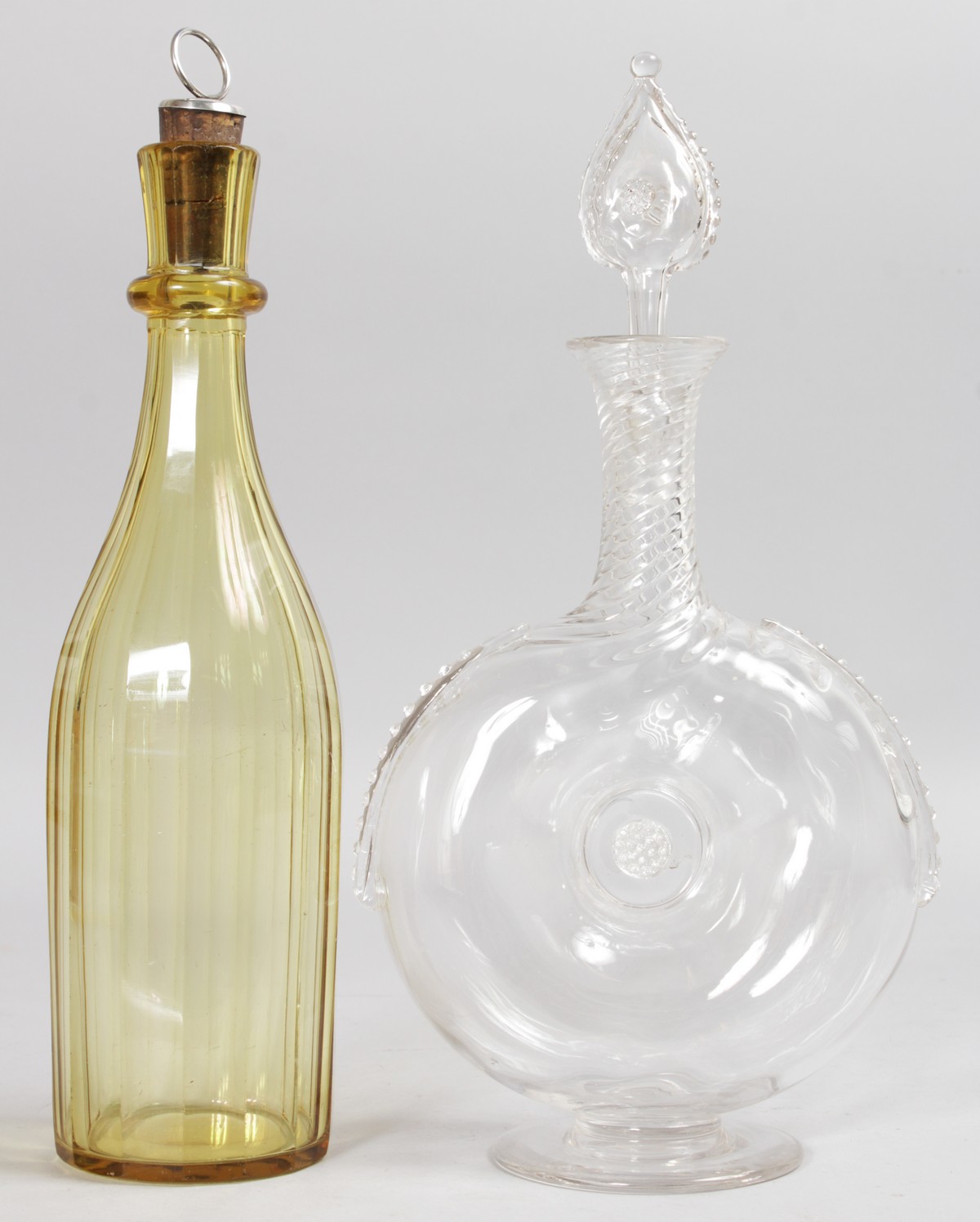 AN AMBER TALL DECANTER AND STOPPER and A LIQUEUR DECANTER AND STOPPER.