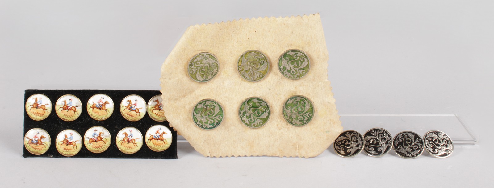 A BAG OF BUTTONS including ten circular enamel equestrian buttons.