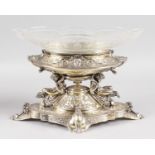 A SUPERB EDWARD VII OVAL CENTREPIECE with engraved and cut glass bowl, the base with cupid