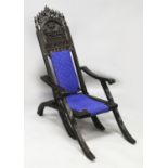 A 19TH/20TH CENTURY SOUTH-EAST ASIAN FOLDING CARVED HARDWOOD CHAIR, the backrest carved with two