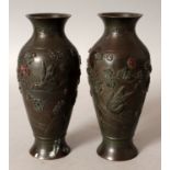 A PAIR OF JAPANESE MEIJI PERIOD BRONZE VASES, each cast in relief with a bird and blossoming boughs,