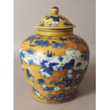 A GOOD QUALITY CHINESE MING STYLE YELLOW GROUND BLUE & WHITE PORCELAIN JAR & COVER, decorated with a