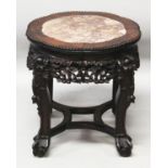 A 19TH CENTURY CHINESE MARBLE TOP HARDWOOD STAND, with shaped pink marble inlay above a pierced vine