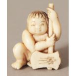 A SIGNED JAPANESE MEIJI PERIOD IVORY NETSUKE OF A SEATED CHILD, bearing an axe, the base with an