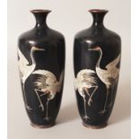 A MIRROR PAIR OF JAPANESE MEIJI PERIOD CLOISONNE VASES, each decorated with a pair of cranes