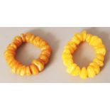 A PAIR OF CHINESE AMBER STYLE PEBBLE BEAD BRACELETS.