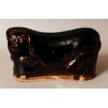 A CHINESE MING STYLE BROWN GLAZED PORCELAIN PILLOW, modelled in the form of a tiger, the base