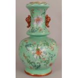 A FINE QUALITY EARLY 19TH CENTURY CHINESE LIME GREEN GROUND FAMILLE ROSE PORCELAIN VASE, the ovoid