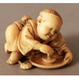 A GOOD QUALITY JAPANESE MEIJI PERIOD IVORY NETSUKE, unsigned, carved in the form of a boy leaning