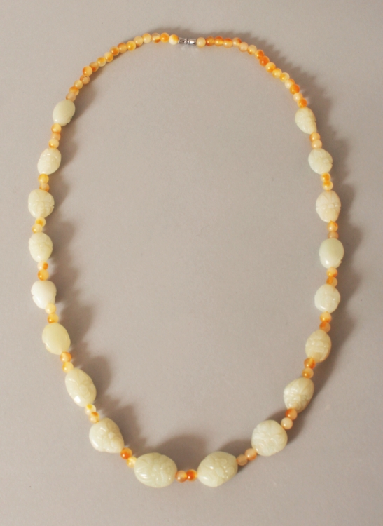 A CHINESE CELADON JADE & AGATE BEAD NECKLACE, the boulder-form jade beads each carved with a mask,