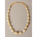 A CHINESE CELADON JADE & AGATE BEAD NECKLACE, the boulder-form jade beads each carved with a mask,