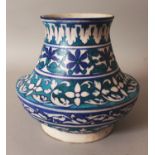 A NORTH AFRICAN ISLAMIC CERAMIC VASE, decorated with formal bands of foliage in turquoise, green and