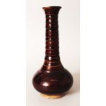 A CHINESE YUAN/MING STYLE BROWN GLAZED CERAMIC VASE, with a slender ribbed neck, the side with a