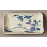 A GOOD QUALITY 18TH/19TH CENTURY NABESHIMA BLUE & WHITE RECTANGULAR PORCELAIN DISH, with indented