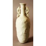 A GOOD QUALITY CHINESE CELADON GLAZED MINIATURE PORCELAIN VASE, the sides moulded in relief with