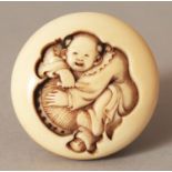 A GOOD QUALITY SIGNED JAPANESE MEIJI PERIOD IVORY MANJU NETSUKE, deeply carved in relief with a