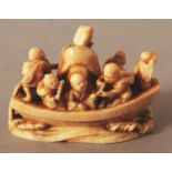 A GOOD QUALITY JAPANESE MEIJI PERIOD IVORY NETSUKE OF A RIVER BOAT, unsigned, the craft bearing