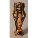 AN UNUSUAL SIGNED JAPANESE MEIJI PERIOD STAINED IVORY NETSUKE OF AN ONI SEA CREATURE, with demonic