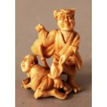 A SMALL SIGNED JAPANESE MEIJI PERIOD IVORY OKIMONO OF AN ONI, the demon subduing with his foot a